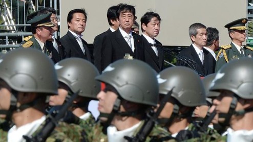 Japanese Prime Minister Shinzo Abe, centre, inspects Self-Defence Force