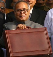 Mukherjee, India's foreign minister and acting finance minister, smiles as he leaves his office to present the interim budget in New Delhi